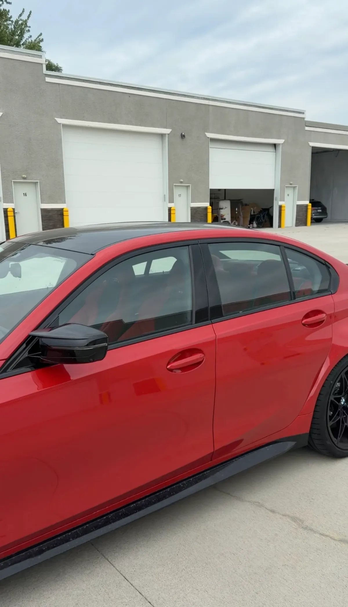 Red BMW side profile before window tint